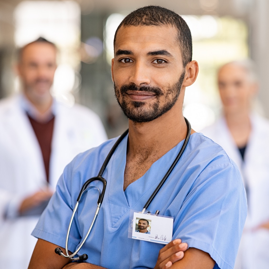 young-confident-male-nurse-looking-at-camera.jpg?s=1024x1024&w=is&k=20&c=MFYrpkecciV7WendLDeiEPlnHmmU2lOIPLLdKuIMADU=